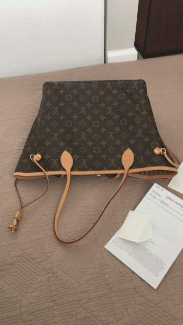 Louis Vuitton “Neverfull MM” Tote coated fabric cowhide leather trim.